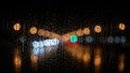 Blurred traffic lights at night viewed through a rain-streaked window. Royalty Free Stock Photo