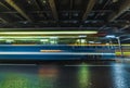 blurred tram under the bridge at night