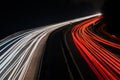 Blurred truck lights. Abstract image of night traffic lights on the road. Car light trails at night in curve asphalt