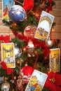 Blurred vertical banner with Tarot card near Christmas decoration.