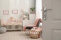 Blurred view of baby room interior with crib