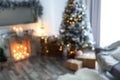 Blurred view of beautiful Christmas tree in room interior Royalty Free Stock Photo