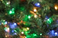 Blurred view of Christmas tree with bright string lights, closeup. Bokeh effect Royalty Free Stock Photo