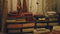 Blurred view of colorful carpets stacked in a store with a bokeh effect, highlighting the textures and patterns in an inviting Royalty Free Stock Photo