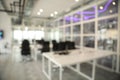 Blurred view of cozy workspaces with tables and chairs in office