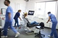 Blurred view of dentists and woman in dentist`s clinic
