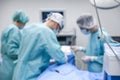 Blurred view of doctors operating patient in room