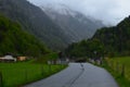 Blurred view of empty asphalt road and buildings in mountains Royalty Free Stock Photo