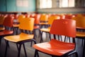 Blurred view of an empty elementary classroom with chairs, devoid of students