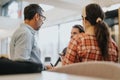 Blurred view of a focused business team having a conversation in a well-lit office space, depicting teamwork and Royalty Free Stock Photo