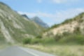 Blurred view of mountains and empty asphalt highway outdoors. Road trip Royalty Free Stock Photo