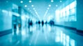 Blurred view of people walking through a bright, modern corridor with reflective flooring and large windows creating a spacious, Royalty Free Stock Photo