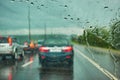 Blurred view of road traffic on a rainy day through the car window Royalty Free Stock Photo