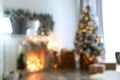 Blurred view of stylish interior with Christmas tree and fireplace Royalty Free Stock Photo