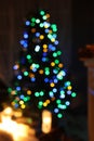 Blurred view of stylish living room interior with Christmas tree and fairy lights Royalty Free Stock Photo