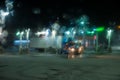 Blurred view of trucks in gas station and snowy road through car windshield covered in snow Royalty Free Stock Photo