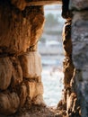 Blurred view through window in old stone fortress in Old Budva town, Montenegro. Architecture concept. Soft focus