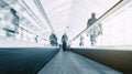 Blurred commuters on a escalator