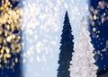 Blurred White Shiny Souvenir Christmas Tree and Its Silhouette, Shadow on Blue Background with Celebration Sparkling Lights Royalty Free Stock Photo