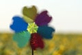 Blurred windmill toy on yellow field background. Alternative energy concept Royalty Free Stock Photo