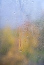 Blurred window background with raindrops on autumn glass