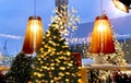 Blurred windows vitrines Christmas festive interior street cafe decoration yellow lamp cup of coffee green tree illumination