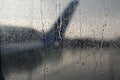 Blurred of wing of airplane see through the rain drop on window Royalty Free Stock Photo