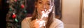 blurred woman in knitted wool white cozy sweater hands holding sparklers bengal fire Royalty Free Stock Photo