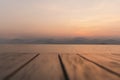 Blurred wooden deck floor with sunrise over river mountain in background. Royalty Free Stock Photo