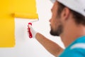 Blurred worker smearing paint on wall