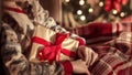 Blurred Xmas compositionwith a girl sitting in a chair, holding a gift
