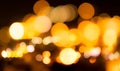 Blurred yellow bokeh background. Blur abstract background of urban light. Warm light with beautiful pattern of round bokeh. Orange