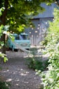 Blurredbackground with trees, vintage camper van and light garland