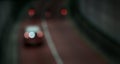 Blurry abstract of automobile, motorcycles driving through tunnel at night in modern city. Beautiful blurred lights of traffic. Royalty Free Stock Photo