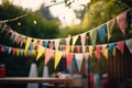 Blurry background of a festive outdoor party with colorful flag adornments