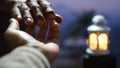 Blurry background of helping hand with light lantern on the blue background. Hands of couple, kindness and humility.