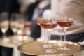 Blurry background of the waiter holds the tray with a glass of champagne to be served Royalty Free Stock Photo