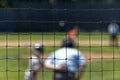 Blurry Baseball Batter seen through fence