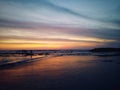 Blurry beach landscape background. Colorful sunset sunrise backgrounds. Dramatic sky colors over horizon. Blurry wave motion.