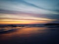Blurry beach landscape background. Colorful sunset sunrise backgrounds. Dramatic sky colors over horizon. Blurry wave motion. Royalty Free Stock Photo