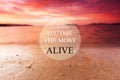 Blurry beach at sunset background with Inspirational quote - Go where you feel the most alive