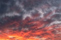 Blurry black rain clouds illuminated by red light from the last rays of the sundown Royalty Free Stock Photo