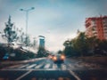 Blurry cars and lights in traffic in a rainy evening seen through windscreen Royalty Free Stock Photo