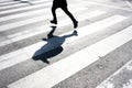 Blurry child and its shadow on zebra crossing