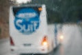 Blurry coach bus on highway in a rainy evening seen through windscreen Royalty Free Stock Photo