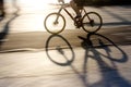 Blurry cyclist silhouette and shadow on a bike lane