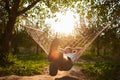 Blurry and defocus relaxing in hammock. man rest in garden. summer vibes in green forest