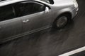 Blurry driving car on the street hit by the heavy rain with hail Royalty Free Stock Photo