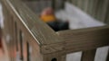 Blurry Fussy Baby in Crib in Dark Nursery