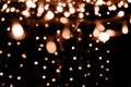 Blurry garland lights on a dark background. Festive Christmas and New Year background. Soft focus. Image toned in color